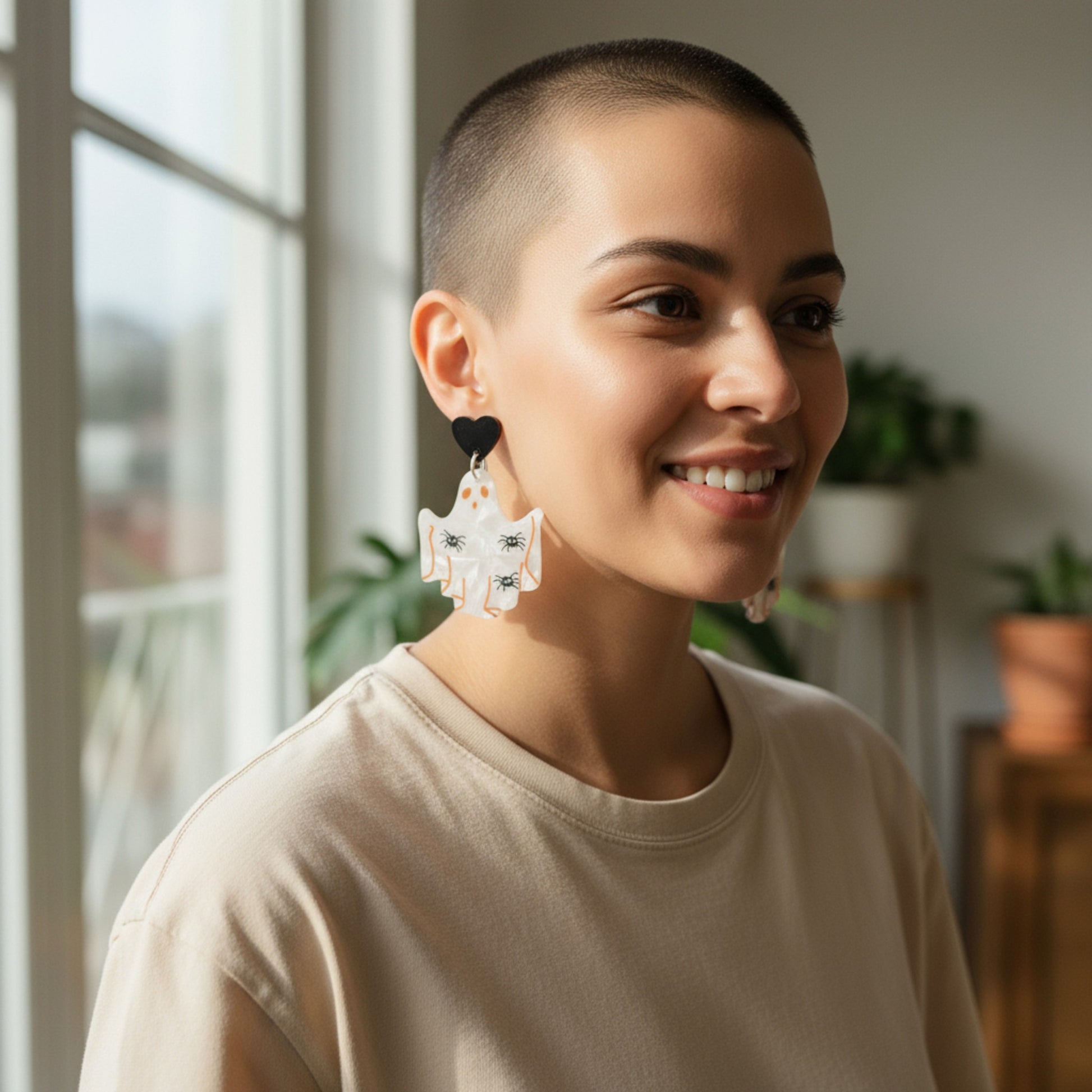 Woman wearing large earrings indoors with a blurred background